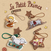 The Little Prince patchwork plush keychain collection with elephant, sheep, and fox styles on beige paper background